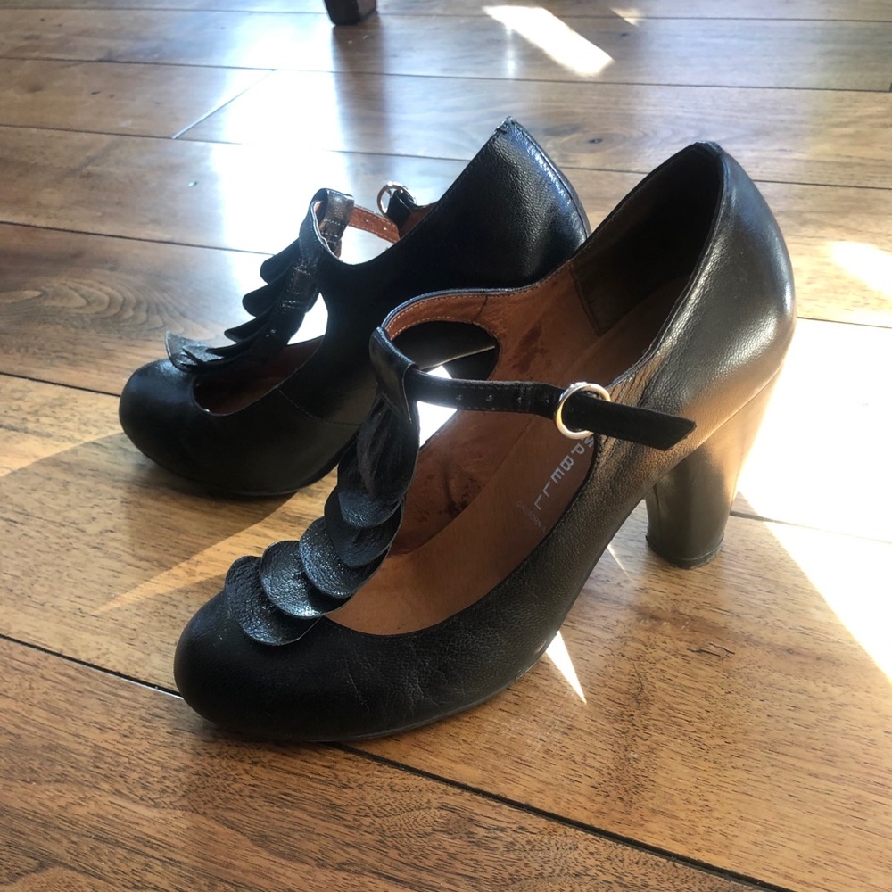 Black leather heals,beautiful ruffle in the front.